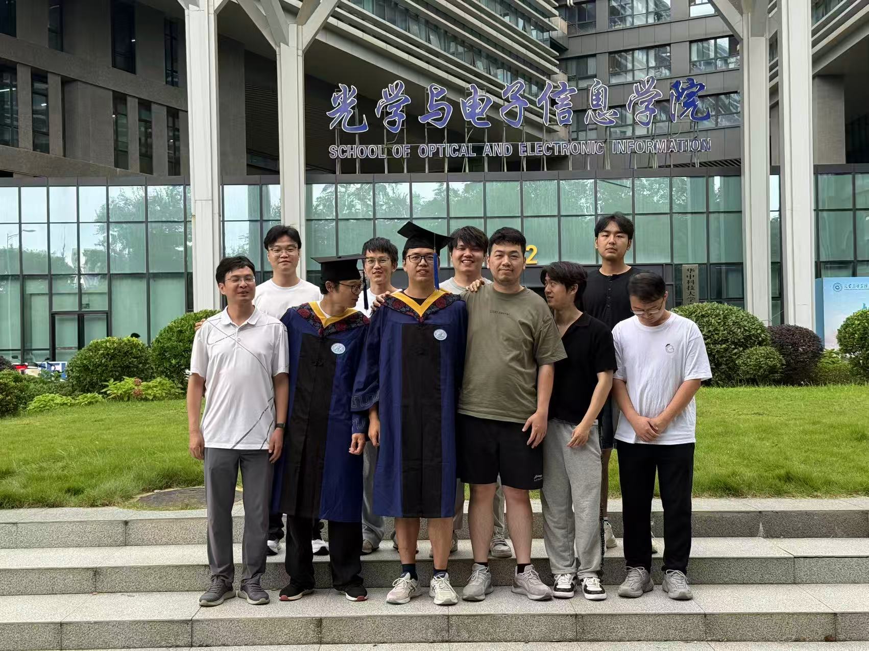 Zhao Group members celebrating graduation outside the School of Optical and Electronic Information